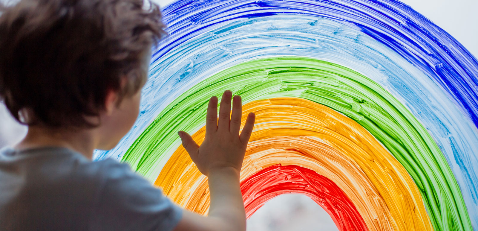 boy painting a rainbow