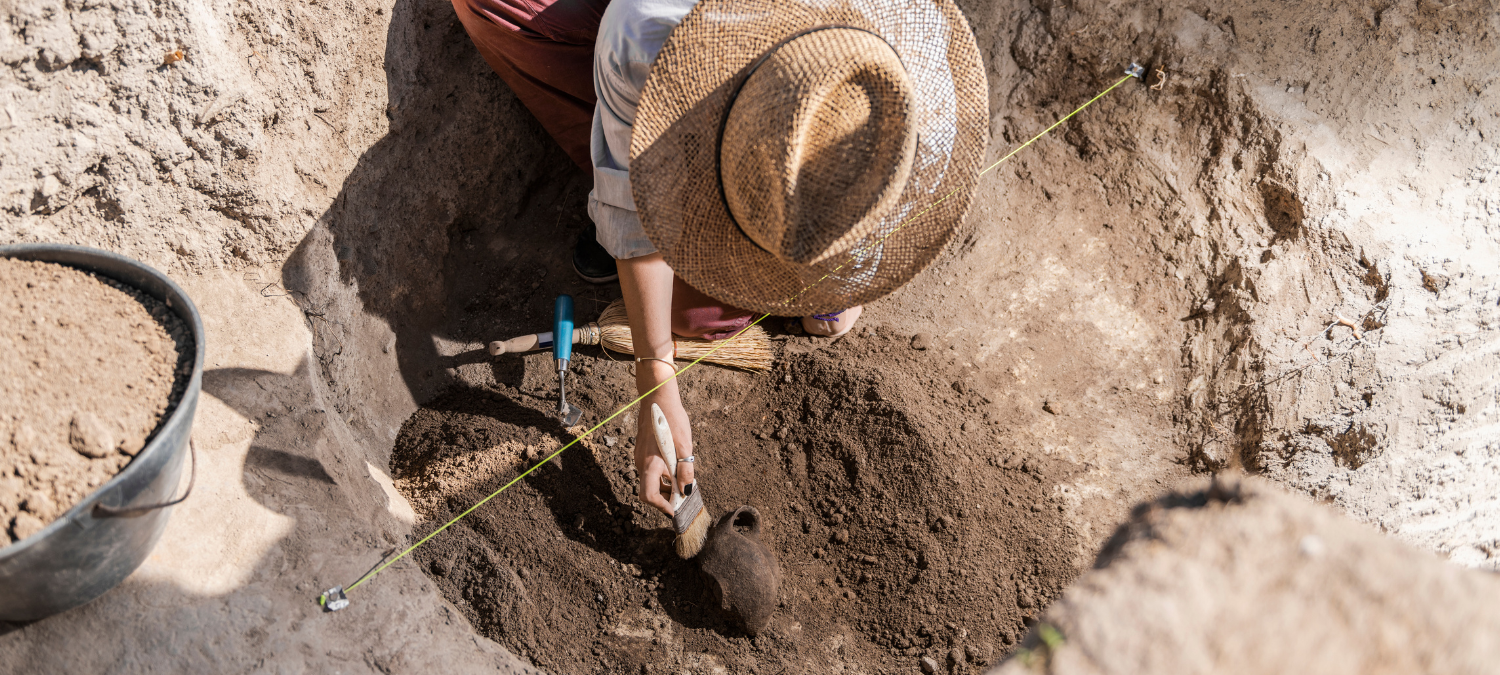 archaeologist uncovering a pot