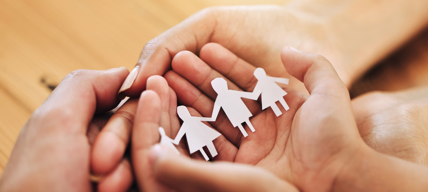 hands holding a paper chain family